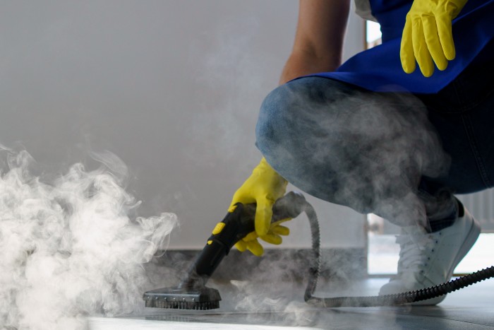 professional-cleaning-service-person-using-steam-cleaners
